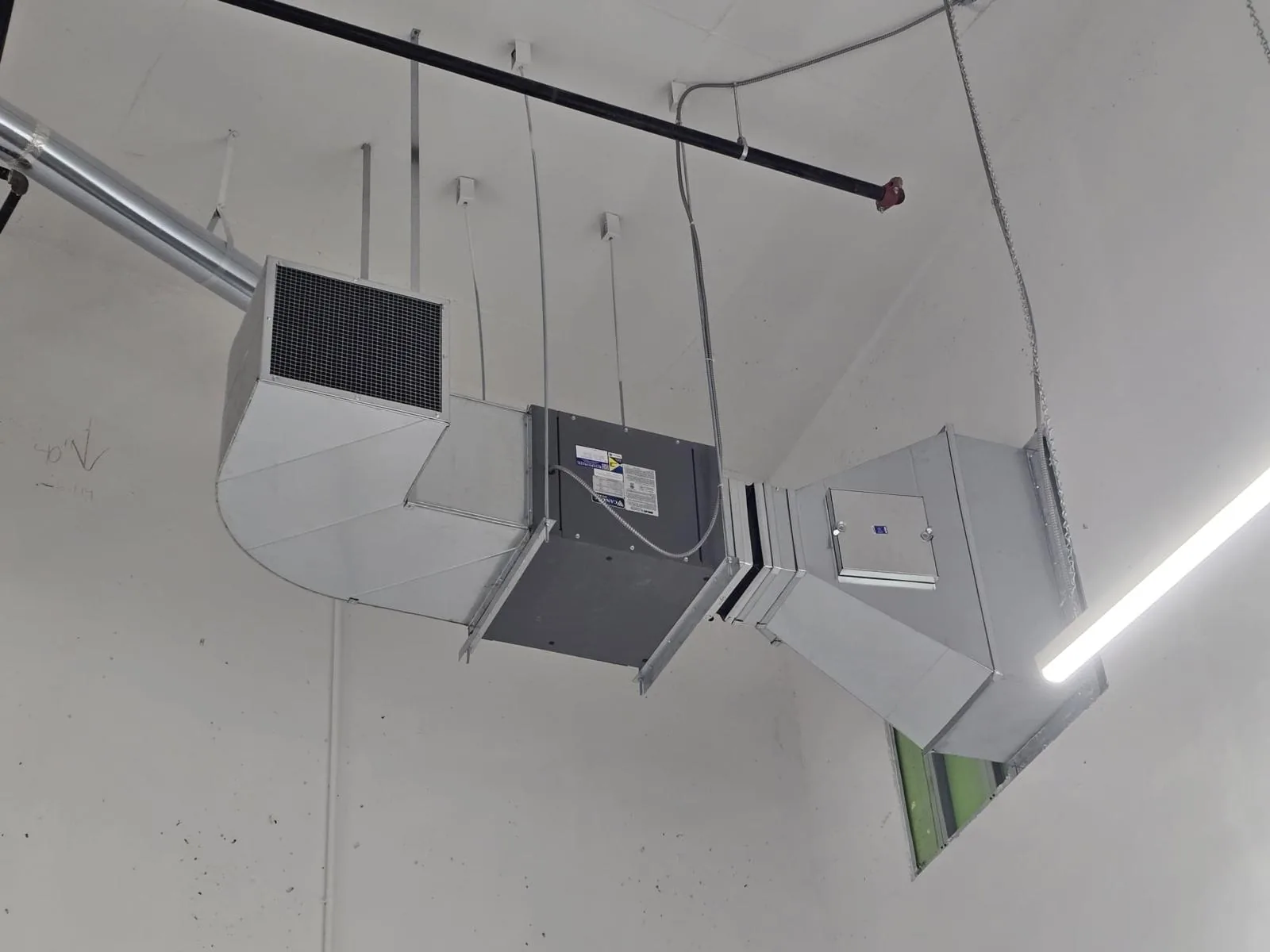 Suspended sheet metal plenum with filter grille, unit housing and access panels overhead